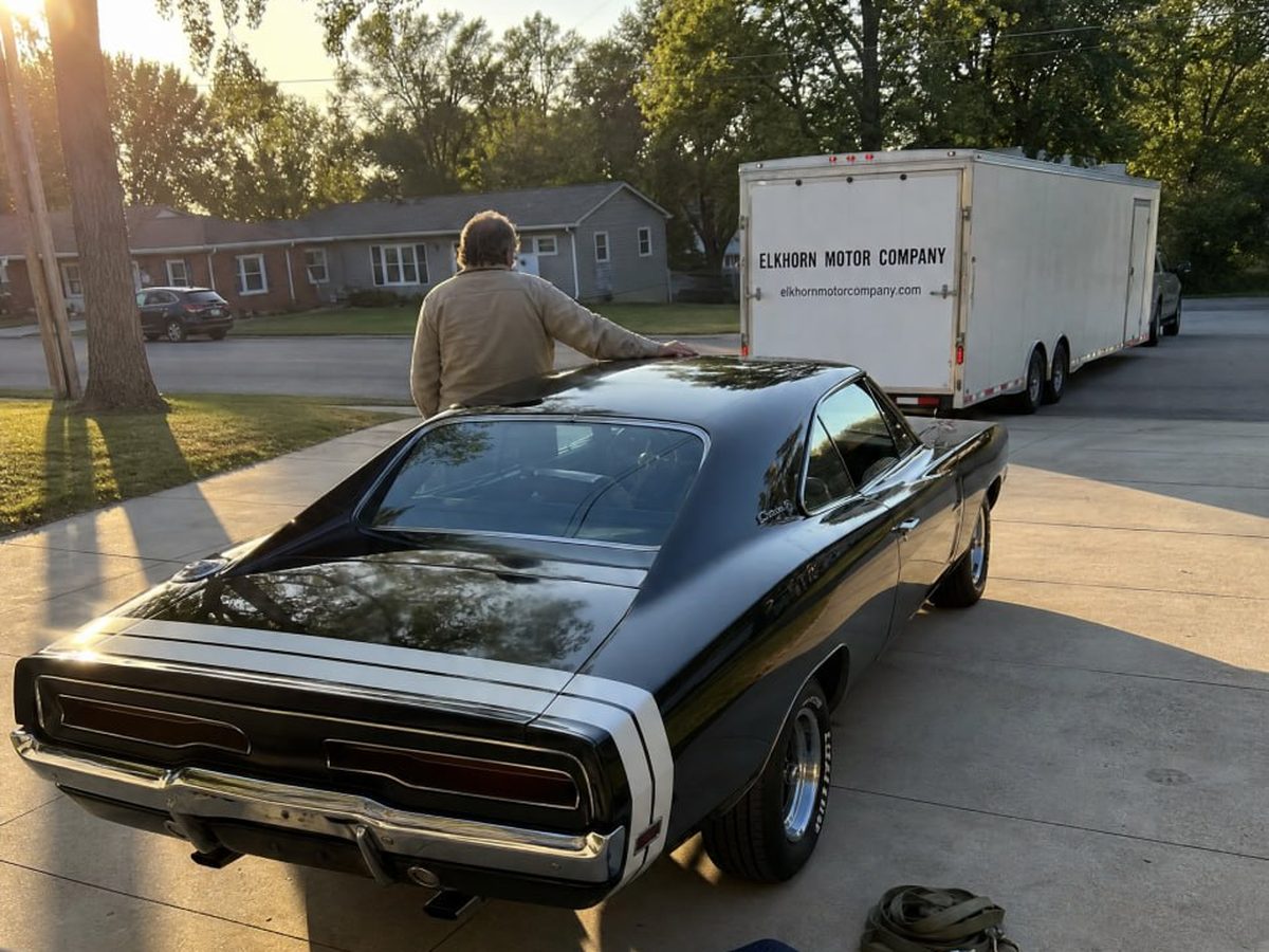 A 1970 Dodge Charger on a customer driveway beside the Elkhorn trailer