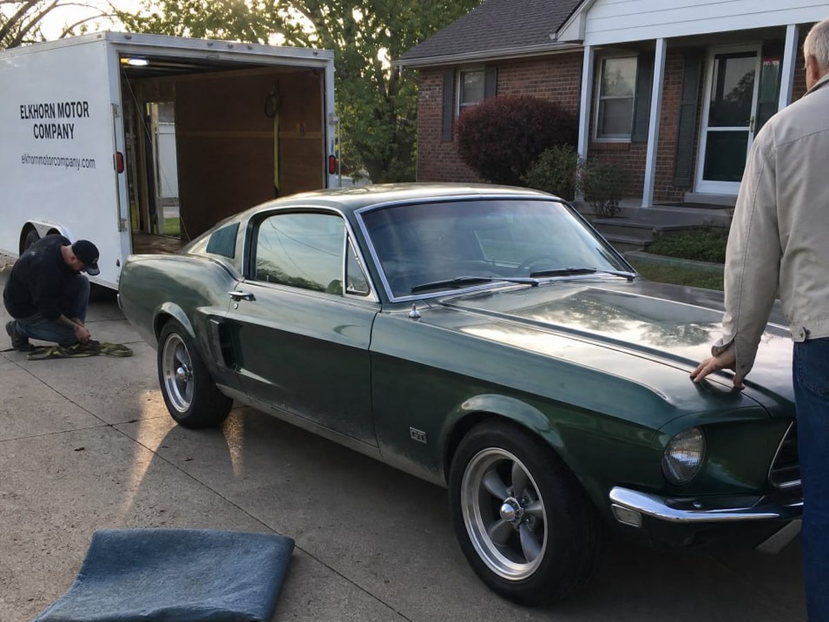 A 1967 Mustang GT being loaded into the Elkhorn Motor Company trailer